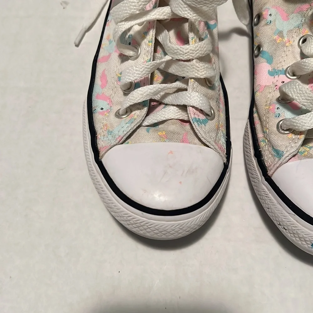 Converse unicorn high top tennis shoe.